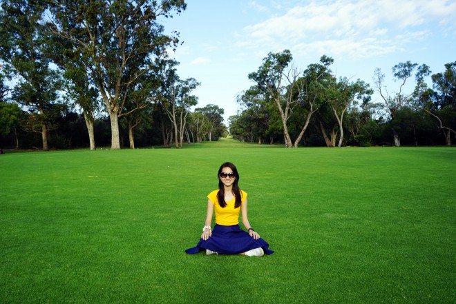 sitting on green grass